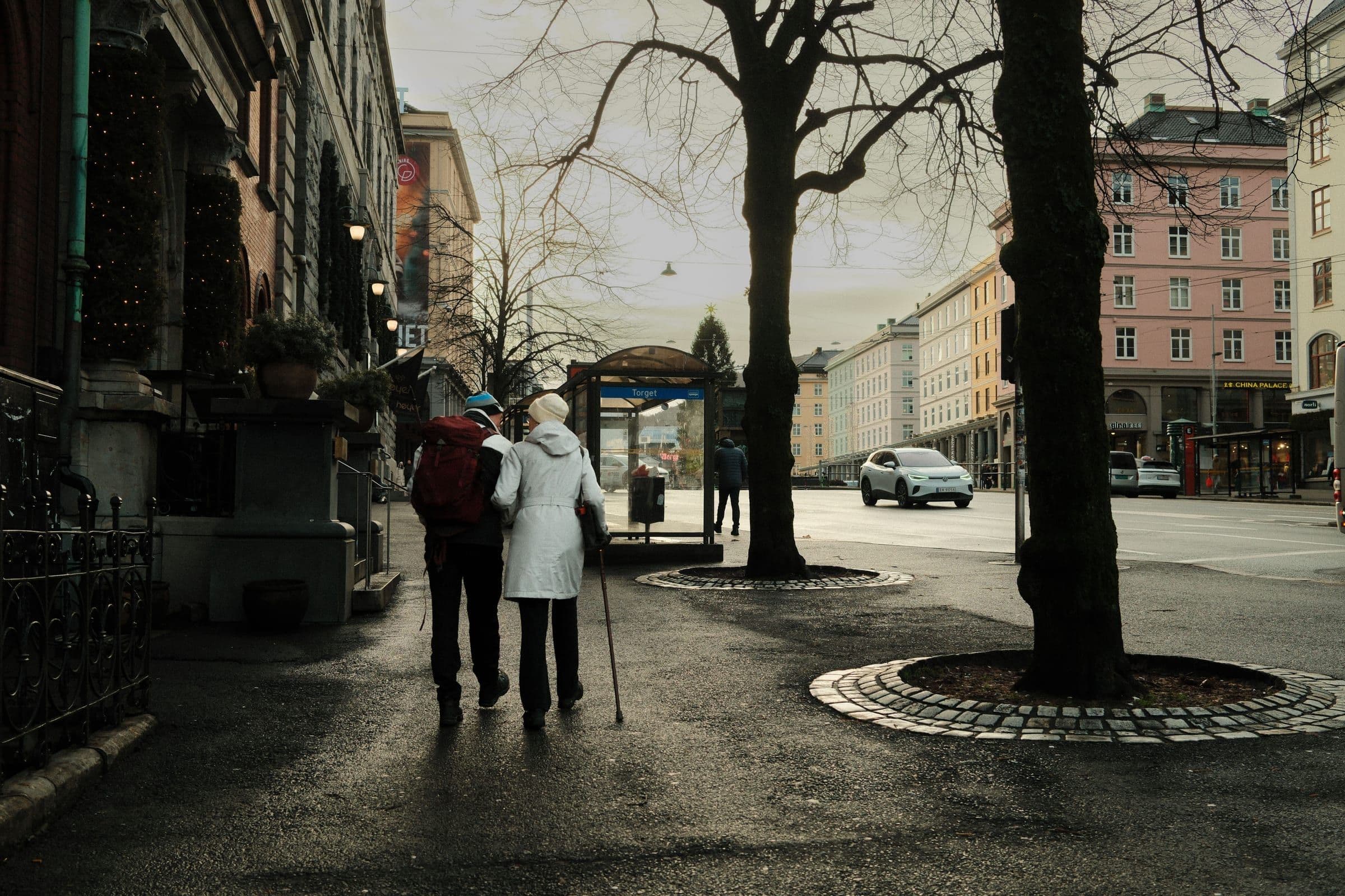 Travelers walking through a European city street.